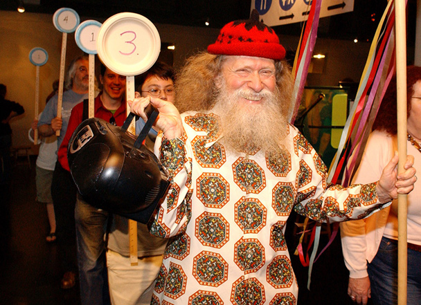 Pi Day founder Larry Shaw leads an Exploratorium pi parade of museum staff and bemused visitors celebrating the never-ending number.