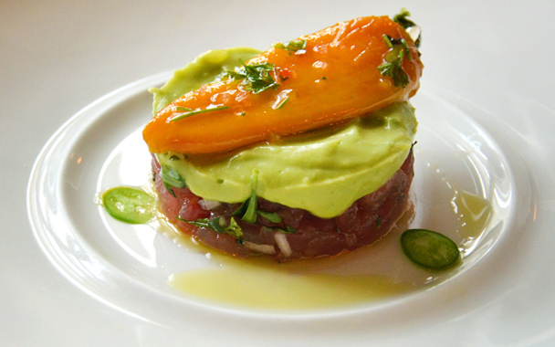 A seafood starter for lunch features tuna tartare with avocado mousse, roasted Tinker Bell peppers, and shaved serrano pepper.